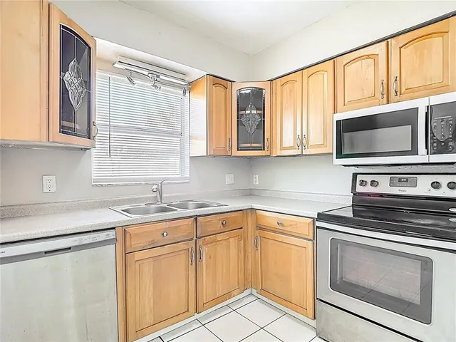a kitchen with stainless steel appliances granite countertop a sink a stove and microwave