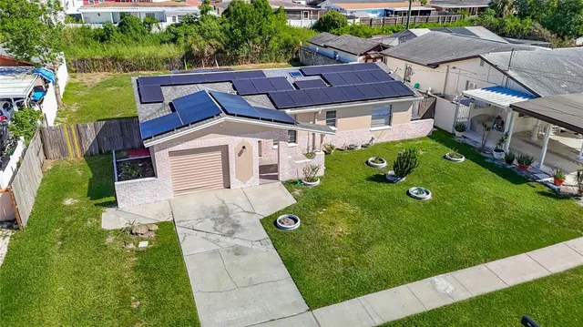 a aerial view of a house with swimming pool and a yard