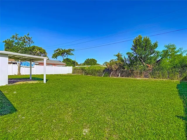a view of a garden with a building in the background