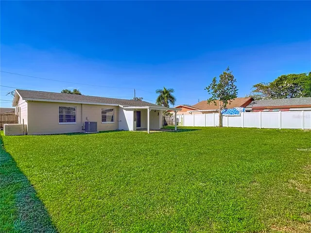 a view of an house with backyard space and garden
