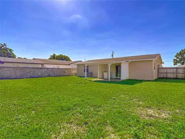 a view of a house with a backyard