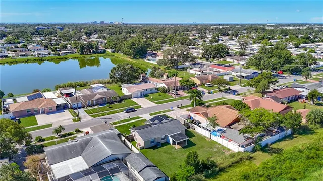 an aerial view of residential houses with outdoor space and swimming pool