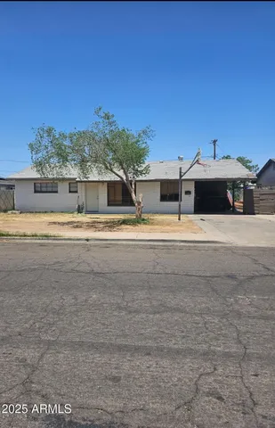 a view of a house with a yard and sitting area