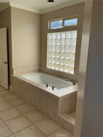a bath tub sitting in a bathroom next to a window