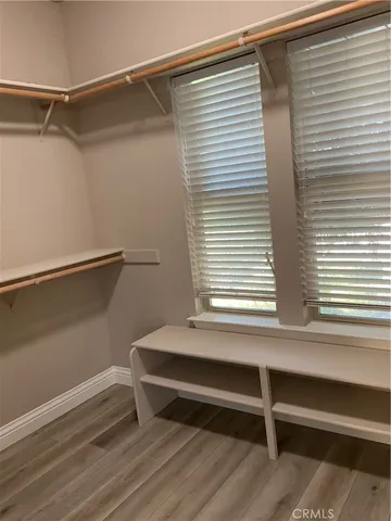 a small space with a bench and a window