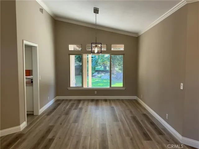 a view of wooden floor and chandelier in a room