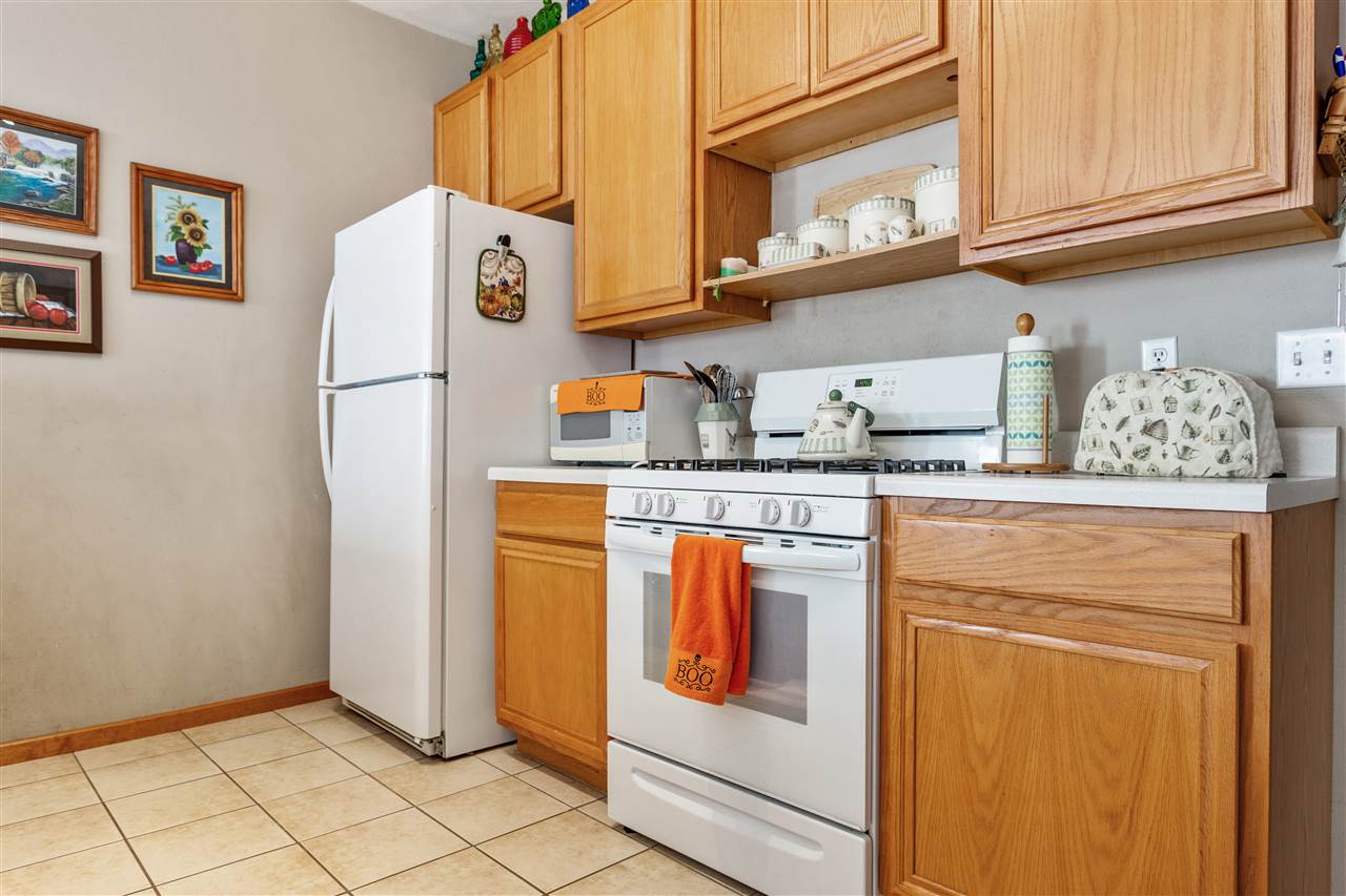10181 Monarch Road, Unit 3 Roscoe, IL 61073 - Photo 7 of 15 a utility room with stainless steel appliances granite countertop a refrigerator and a stove