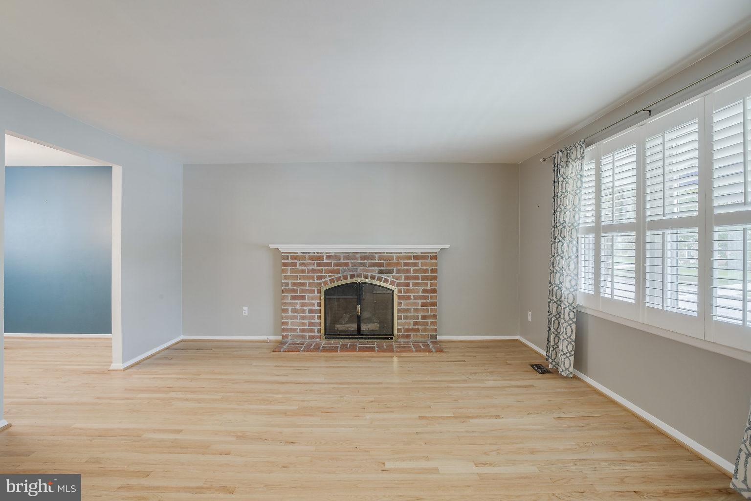 517 Bathurst Road Baltimore, MD 21228 - Photo 4 of 27 Living rm w/plantation shutters & fireplace!!