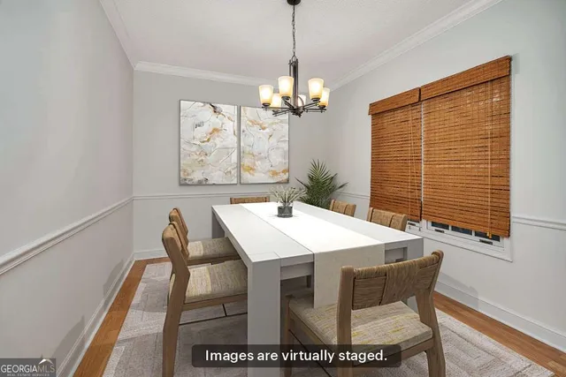 a view of a dining room with furniture and a chandelier