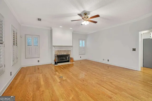 a view of empty room with fireplace and fan