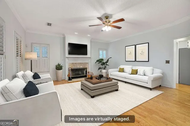 a living room with furniture a fireplace and a flat screen tv