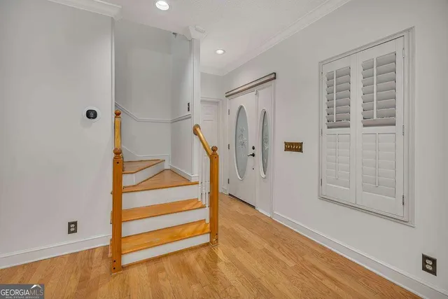 a view of entryway with wooden floor and cabinet