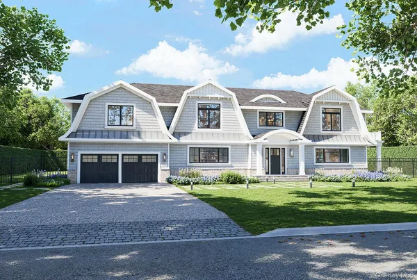 a front view of a house with a garden and trees