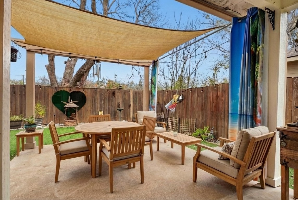7800 Duber Lane Austin, TX 78747 - Photo 13 of 34 Virtually staged - View of patio featuring outdoor dining space and artificial turf