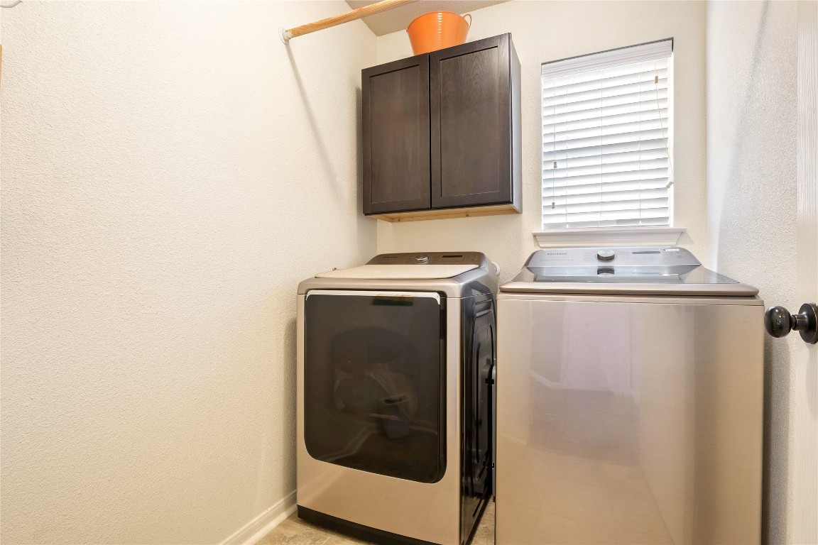 7800 Duber Lane Austin, TX 78747 - Photo 25 of 34 Laundry area with cabinet space and independent washer and dryer