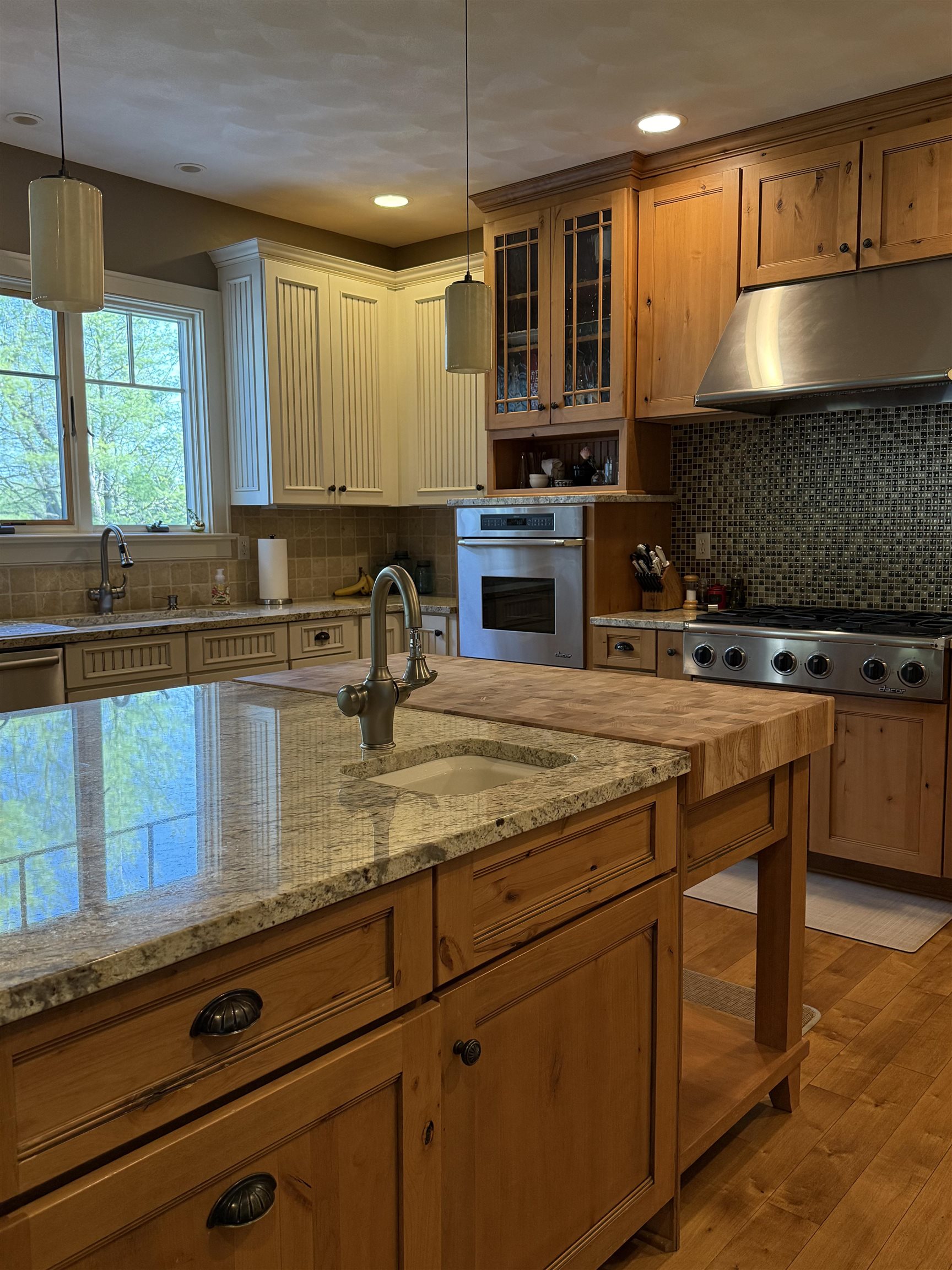 7432 Timber Ridge Road Roscoe, IL 61073 - Photo 10 of 17 a kitchen with kitchen island granite countertop a sink a counter space appliances and cabinets