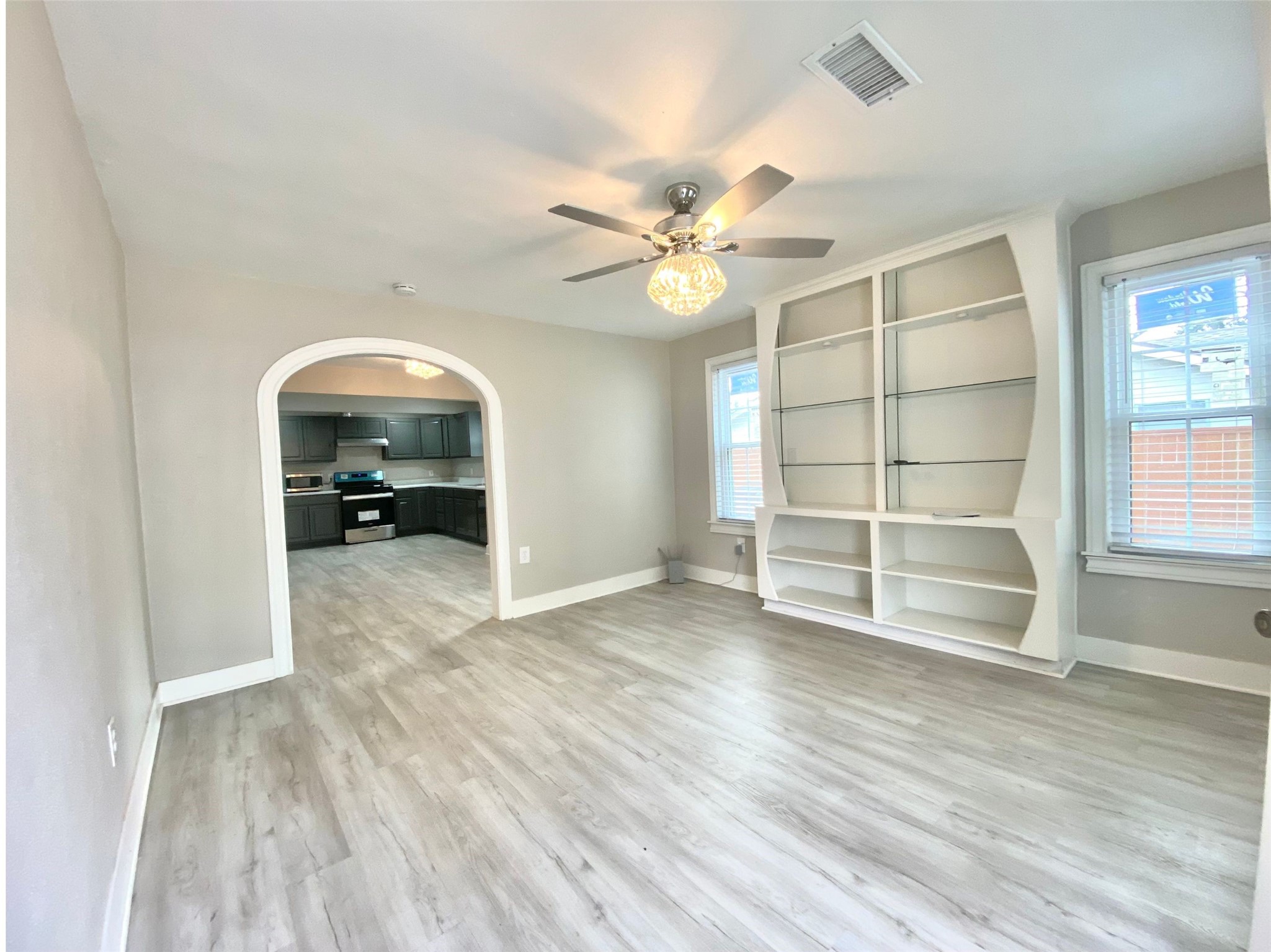 628 King Street Houston, TX 77022 - Photo 7 of 24 Enter to the spacious and bright living room with built-in shelve display. Remote for light/fan fixture, lights in built-in add convenience.