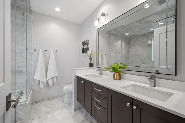 a bathroom with a double vanity sink and a mirror