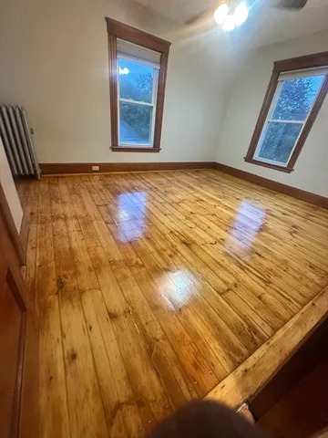 a view of an empty room and wooden floor