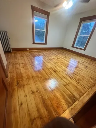a view of an empty room and wooden floor