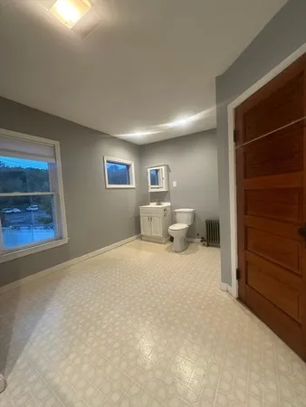 a room with bed and window