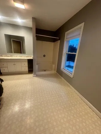 a view of empty room with a fireplace