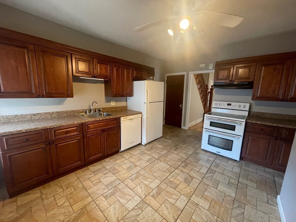 136 Ferry Street, Unit 2 Grafton, MA 01560 - Photo 6 of 29 a kitchen with stainless steel appliances a stove a sink and a refrigerator