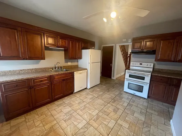 a kitchen with stainless steel appliances a stove a sink and a refrigerator