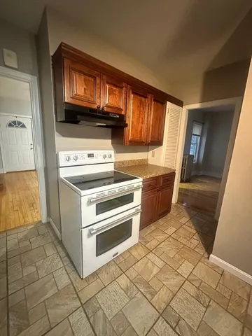 a kitchen with stainless steel appliances a stove a sink and a refrigerator