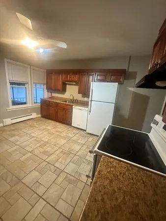 a kitchen with a stove and a refrigerator