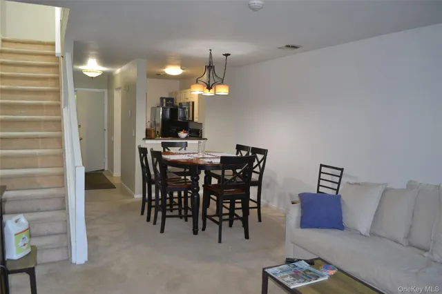 a dining room with furniture and a chandelier