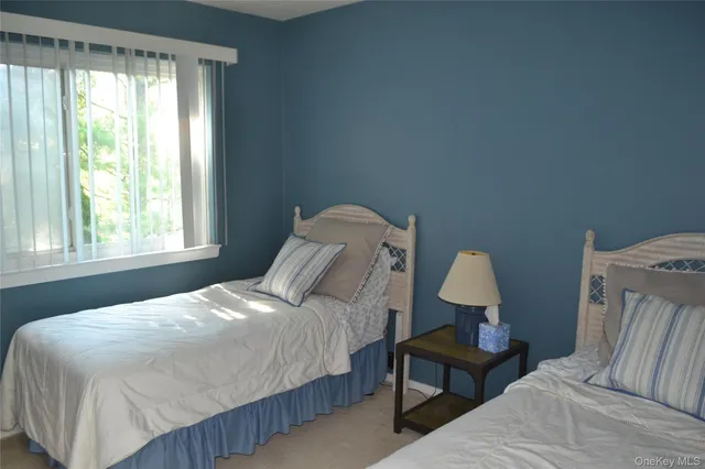 a bedroom with a bed wooden floor and window