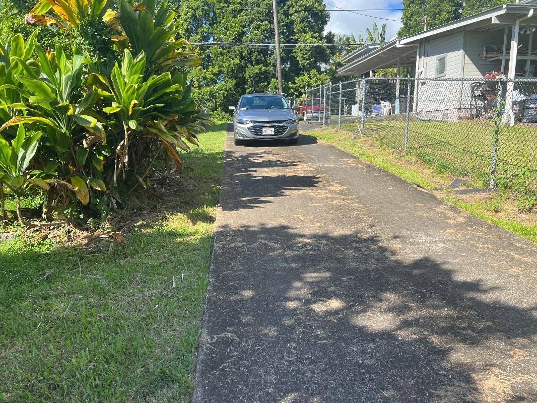 430 Kaiwiki Road Hilo, HI 96720 - Photo 3 of 16 a backyard of a house with table and chairs