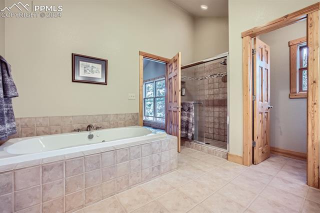 182 Joshua Road Divide, CO 80814 - Photo 24 of 35 Bathroom featuring plus walk in shower and tile patterned flooring