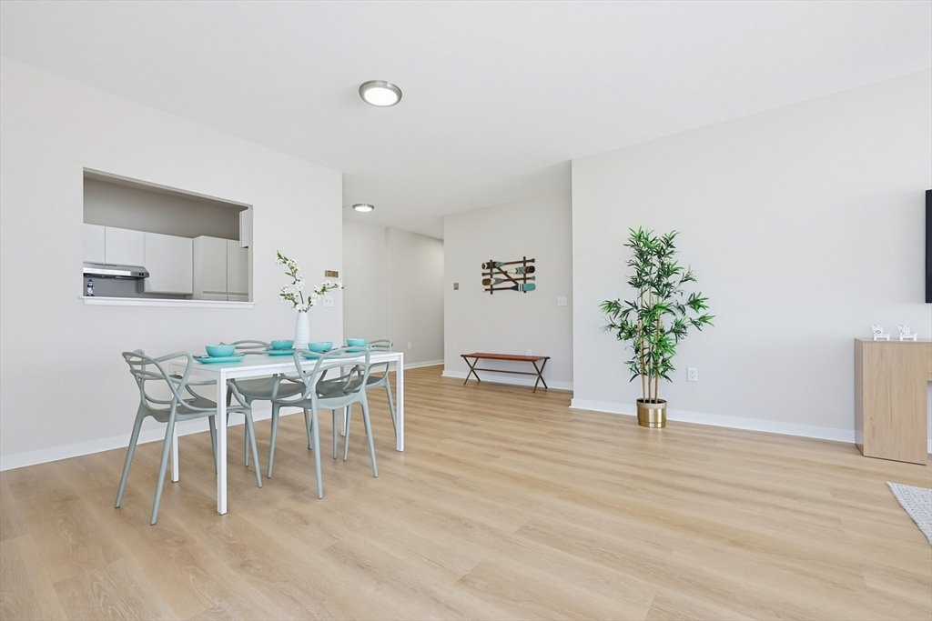 45 Main Street, Unit 35 Wareham, MA 02571 - Photo 9 of 34 a dining room with furniture potted plants and wooden floor