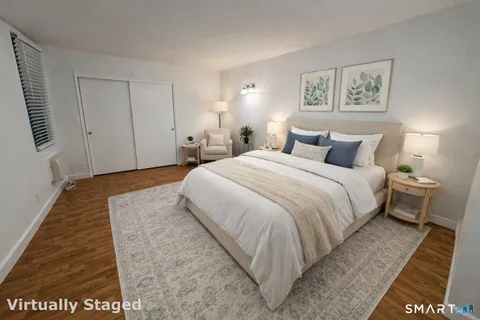 a living room with furniture and dresser