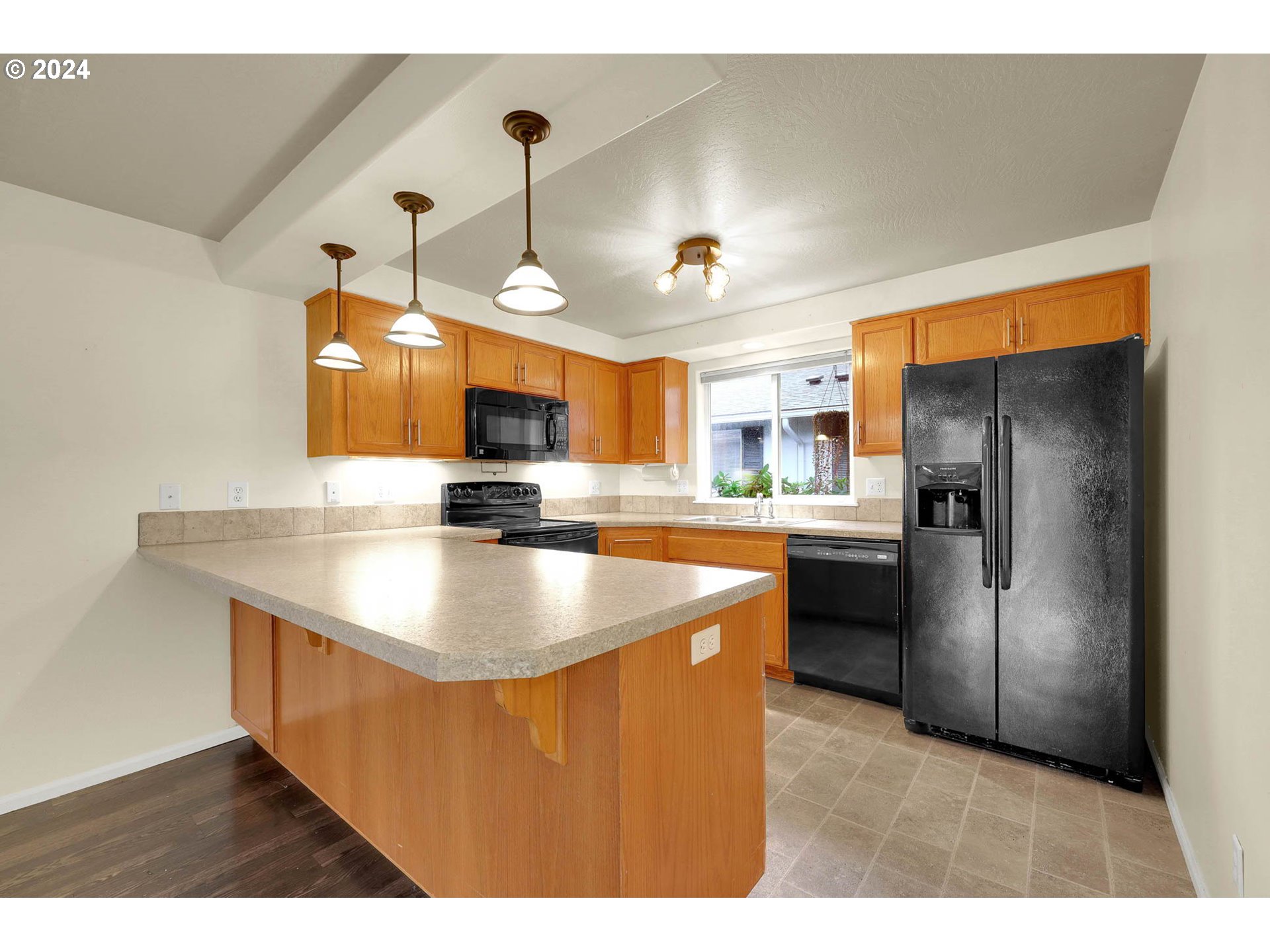 972 West L Street Springfield, OR 97477 - Photo 7 of 27 a kitchen with stainless steel appliances granite countertop a sink a refrigerator and a stove