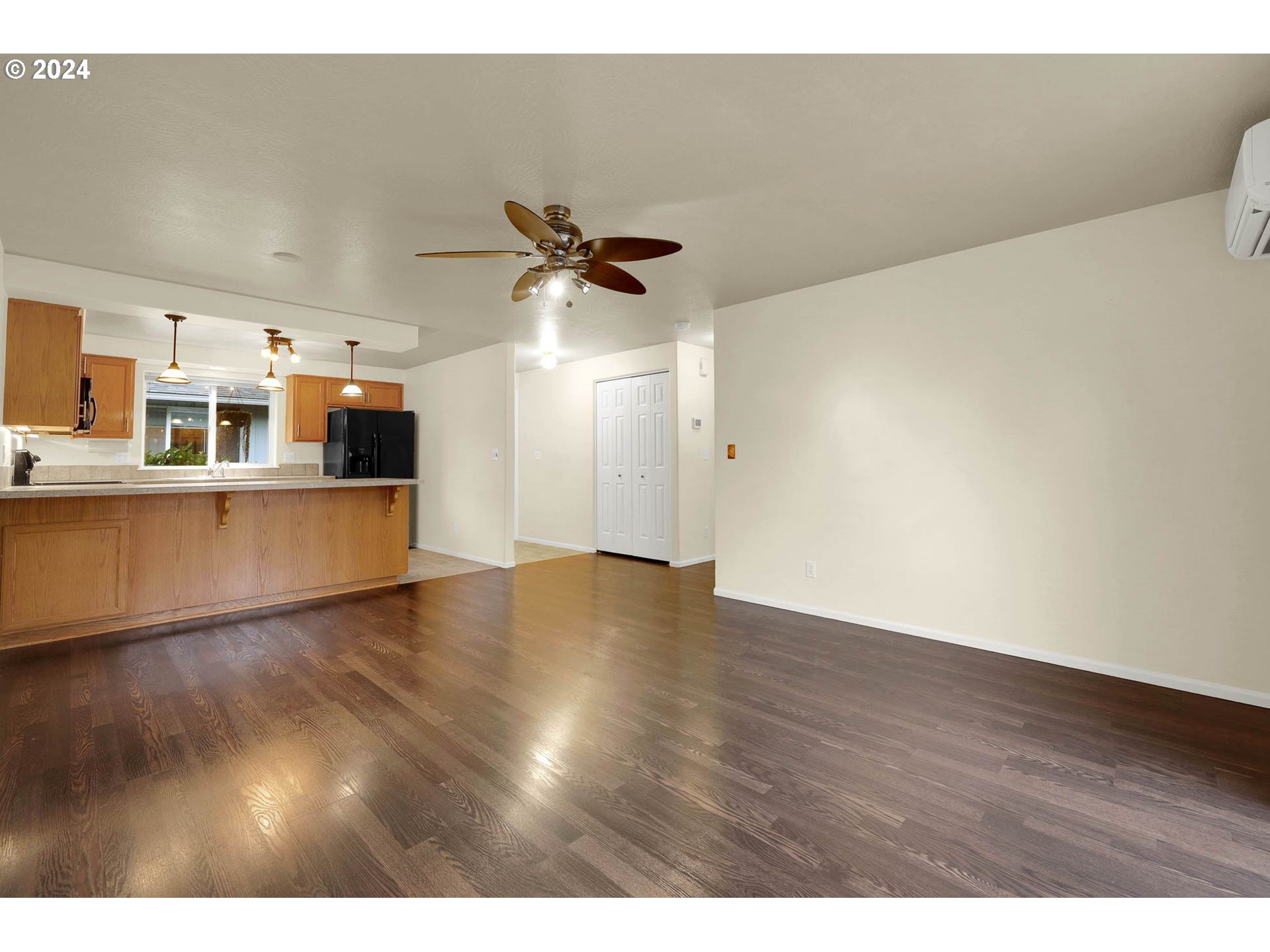 972 West L Street Springfield, OR 97477 - Photo 9 of 27 a view of a room with wooden floor and a ceiling fan