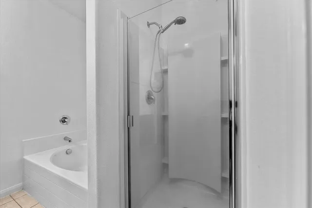 a bathroom with a tub shower and sink