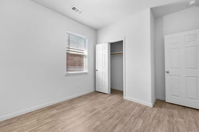 a view of a livingroom with wooden floor and window
