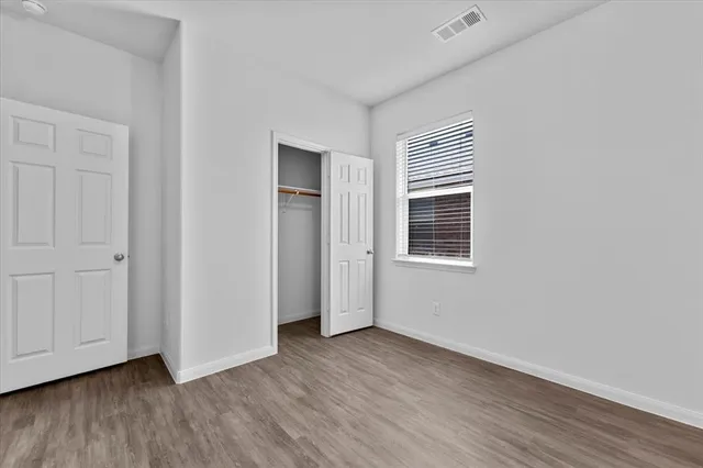 a view of a livingroom with wooden floor and window