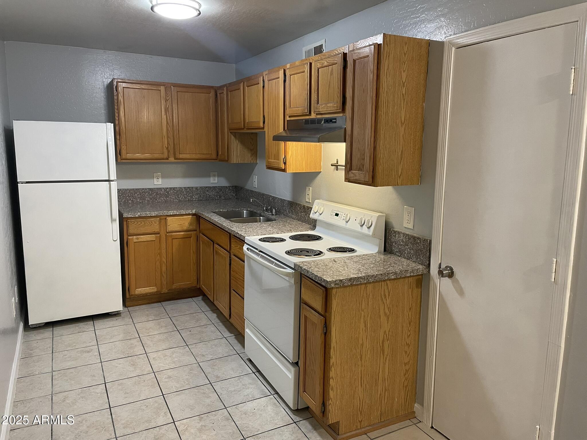 602 East Townley Avenue, Unit 305 Phoenix, AZ 85020 - Photo 1 of 21 a kitchen with a sink a stove a refrigerator and cabinets