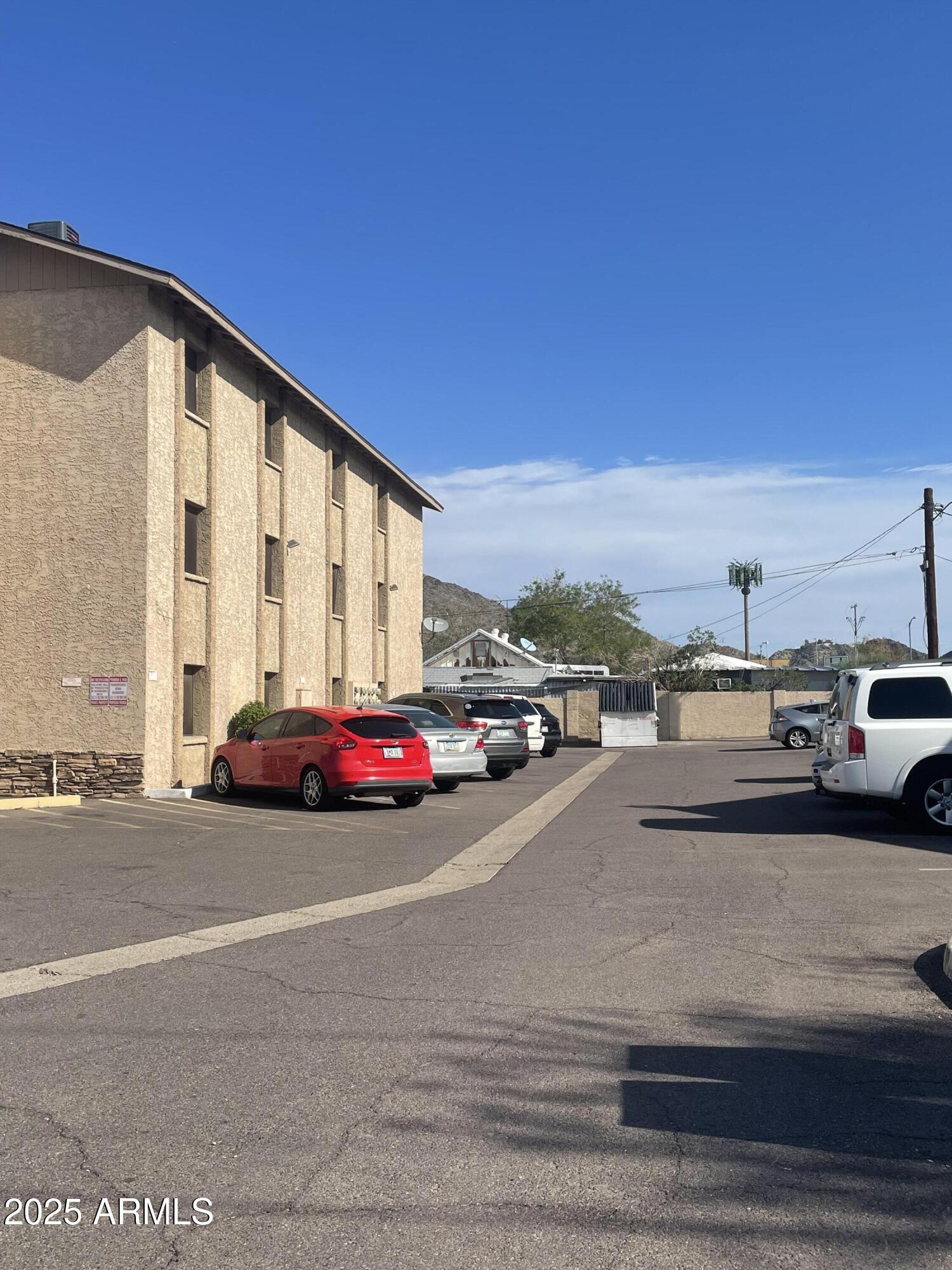 602 East Townley Avenue, Unit 305 Phoenix, AZ 85020 - Photo 16 of 21 a view of building with cars parked on road