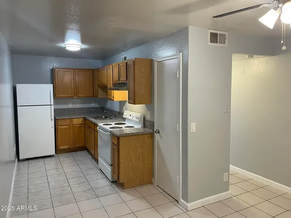 a kitchen with a stove a refrigerator and a sink