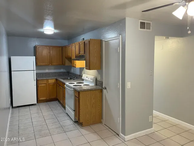 a kitchen with a stove a refrigerator and a sink