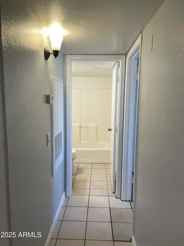 a bathroom with a shower and a mirror