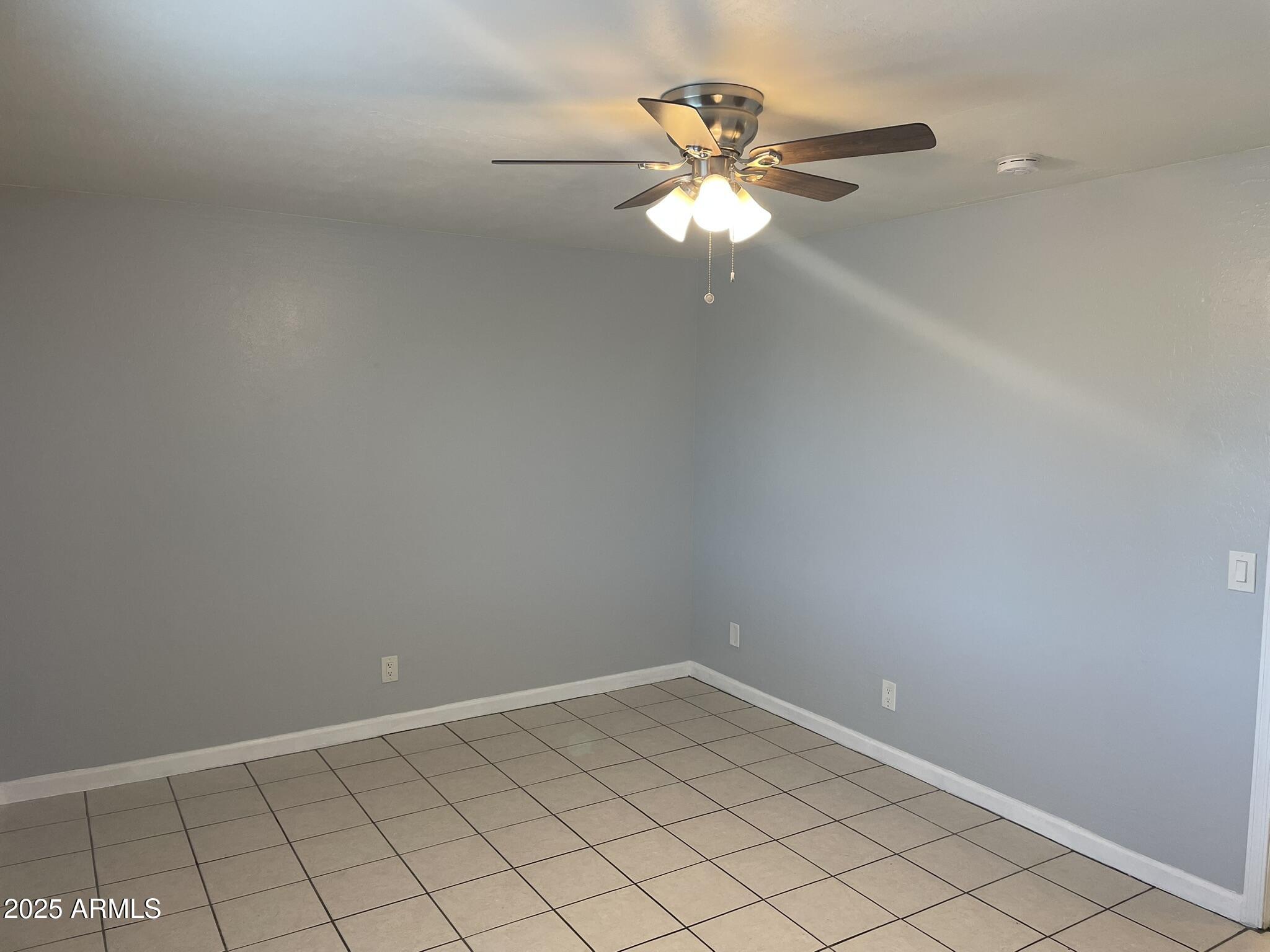 602 East Townley Avenue, Unit 305 Phoenix, AZ 85020 - Photo 10 of 21 an empty room with chandelier fan