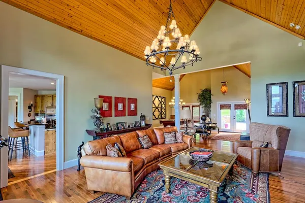 a living room with furniture and floor to ceiling windows