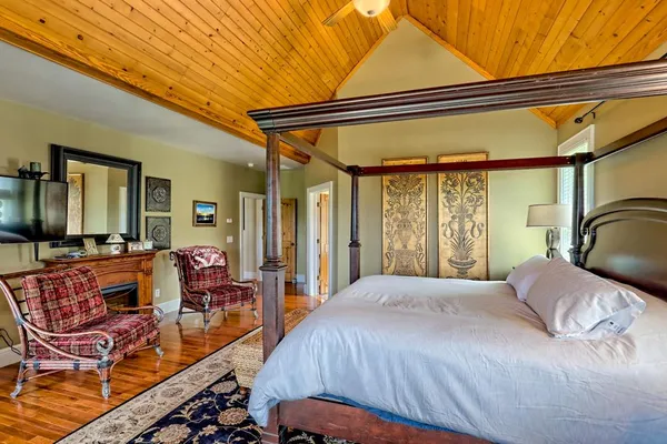 a living room with furniture a large window and wooden floor