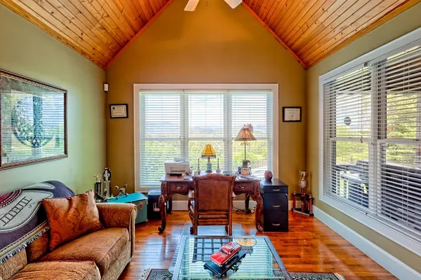 a kitchen with stainless steel appliances wooden floor dining table and chairs